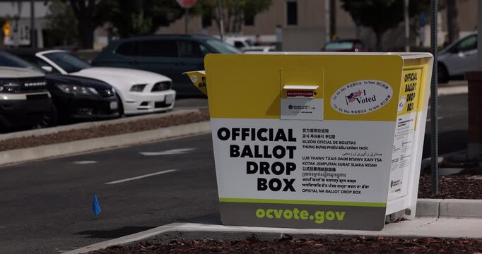 Fullerton, California, USA - August 14, 2026: An official ballot drop box stands on a city street to collect mid term election ballots.