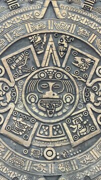 Close details of sculpture inspired by the Aztec calendar with carved stone details, vertical