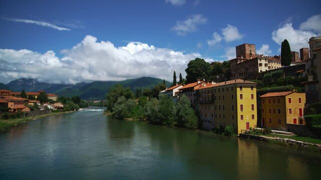 View from Ponte degli Alpini wooden bridge in Bassano del Grappa to the river in green landscape