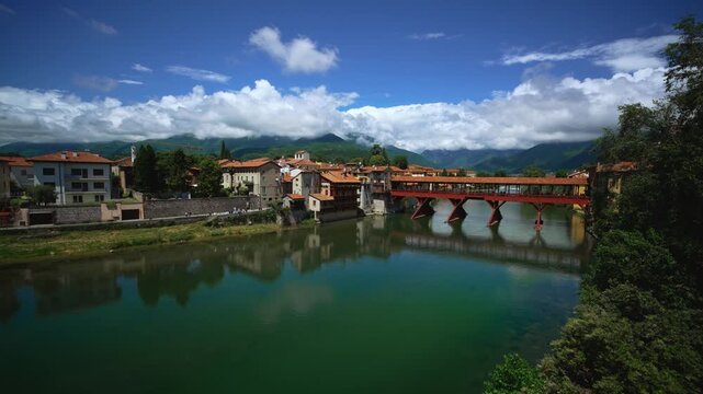 View of Ponte degli Alpini, river and Dolomite mountains in Bassano del Grappa, Italy. Sunny day