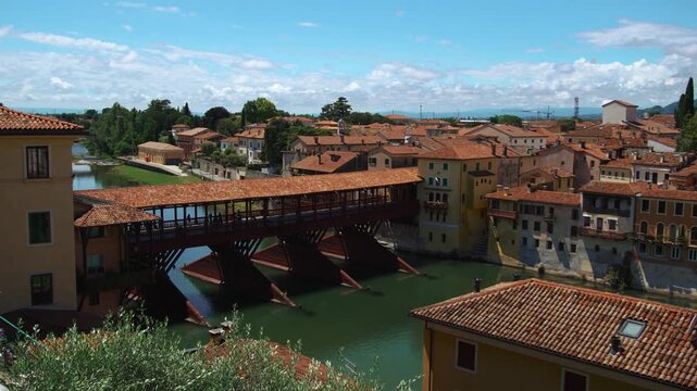 Historic buildings at river bank near the famous Alpine bridge in Bassano del Grappa. Ponte degli Alpini