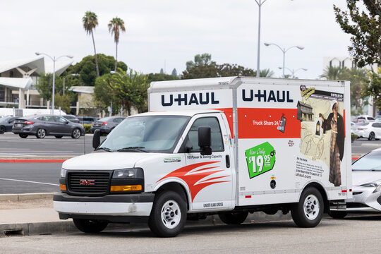 Fullerton, California / USA - August 14, 2026: A UHAUL Van parks on a city street.