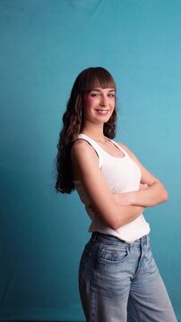 Confident young woman posing and winking at the camera