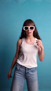 Trendy young woman with sunglasses dancing