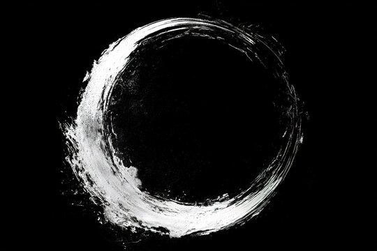 Abstract brush stroke circle painted in white paint on solid black background minimalist art design for modern graphics.