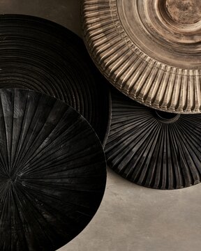Crated eco-friendly tire patterns resting beside charred rota coils along a datum plane