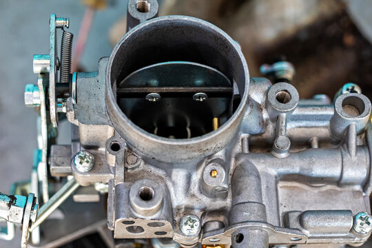 View of the carburetor throttle valve. A carburetor (also spelled carburettor or carburetter) is a device used by a gasoline internal combustion engine to control and mix air and fuel entering.