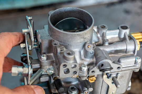 View of the carburetor throttle valve. A carburetor (also spelled carburettor or carburetter) is a device used by a gasoline internal combustion engine to control and mix air and fuel entering.