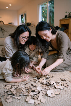 Diverse Family Assembling Wooden Puzzle Authentic Bonding Domestic Realism Fun Cozy Indoor