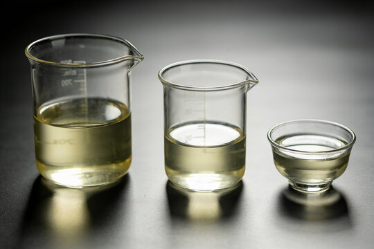 Three glass vessels of different sizes hold the same volume of liquid