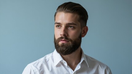 Obraz premium Handsome Young Man with Beard and White Shirt on Blue Background