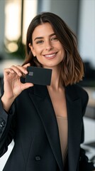 Obraz premium Smiling Young Businesswoman Holding Credit Card for Digital Payment