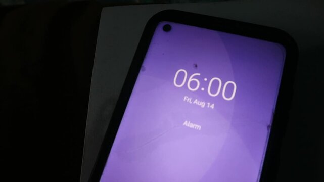 A close up view of a smartphone screen showing the time at six o clock in the morning. ideal for concepts of morning routines, time management, early wake-up habits, and daily schedules.