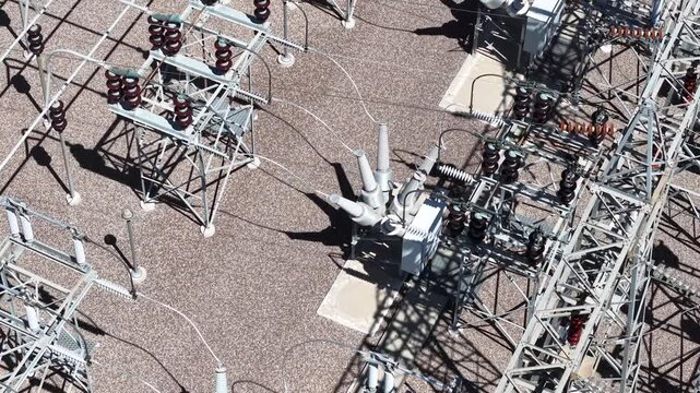 High-Angle Pan Across High-Voltage Circuit Breakers in Electrical Substation