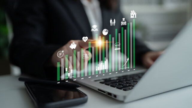 Business professional analyzing economic growth with digital graphs and data on a laptop, showcasing insights and technology in finance and investment Quark.