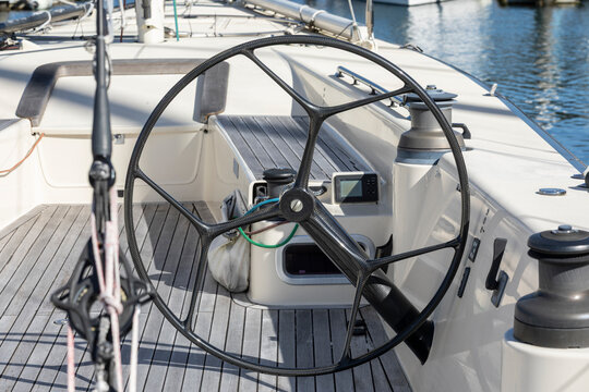 Sailing boats at a marina on a sunny day. Large Steering wheels for ocean racing.