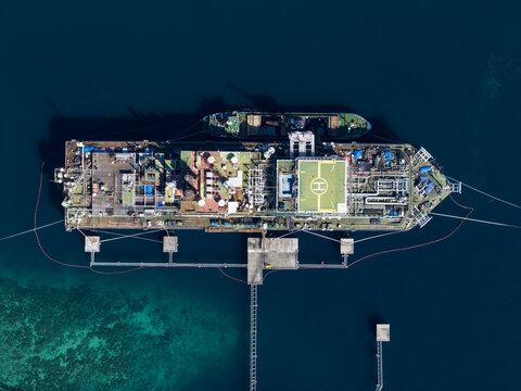 Aerial view of a Floating Storage and Offloading Ship moored at sea with industrial infrastructure and a helipad in Buleleng Regency, Bali, Indonesia.