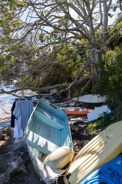 Dinghy and clothes getting ready to row to the boat on a mooring. Bush setting by the harbor.