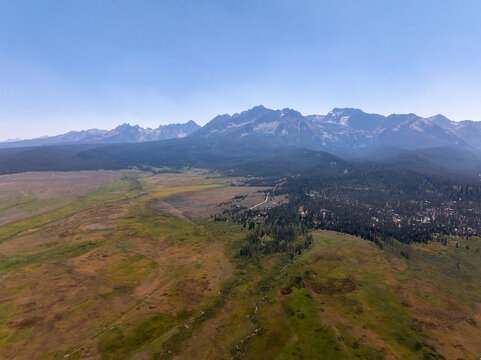 High-angle view captures expansive grasslands and forested areas