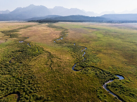 Aerial shot captures lush grasslands and a curving river
