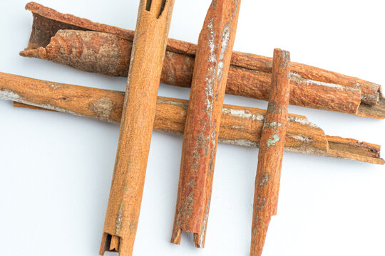 Cinnamon sticks arranged in crossed and star pattern isolated on white background