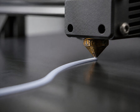 Precision 3D printer nozzle extruding curved filament path