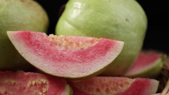 Fresh red-fleshed guavas in a basket	