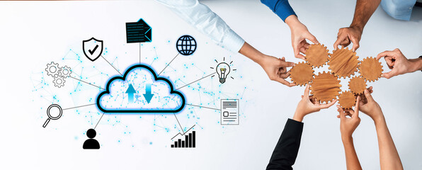 Obraz premium Diverse Hands Collaborating Around Cloud Technology Concepts and Gear Symbols for Data Sharing and Internet Solutions in Modern Workspaces. Entropy.