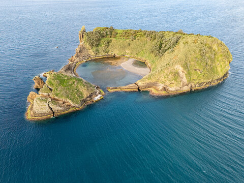 Aerial view of Ilheu de Vila Franca do Campo, a volcanic islet with a natural circular lagoon, surrounded by the Atlantic Ocean, Sao Pedro, Acores, Portugal.
