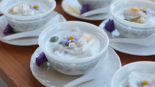 Bua Loi . Thai Glutinous Rice Balls in Coconut Milk.Royal Thai dessert Bua Loi, glutinous rice dumplings in warm sweet coconut milk topped with edible flowers.