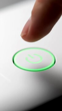 Finger touching a glowing green button, representing technology and interaction.