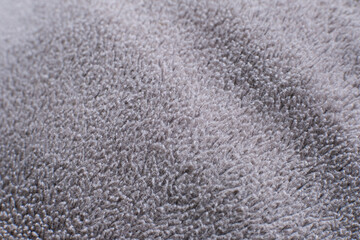 Soft gray towel texture, plush and inviting. Fiber details appear dense and gentle. Ideal for home decor or textile design projects.  © Gigih
