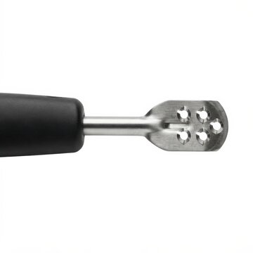 Close-up of stainless steel citrus zester with fresh lemon peel