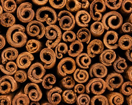 Macro background of curled cinnamon sticks
