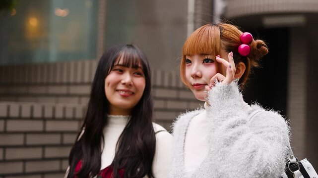 Two Japanese Women in Harajuku Fashion Posing on Tokyo Street