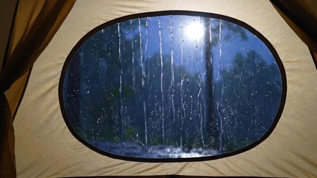 View from a tent window during a heavy rainstorm moonlit night forest background atmospheric outdoor adventure camping