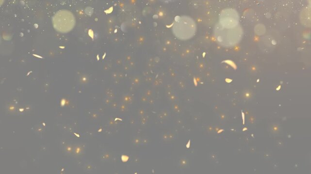 Golden particles and floating leaf shapes create a glowing bokeh background.