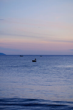 Minimalist photograph of a traditional basket boat on the sea at dawn