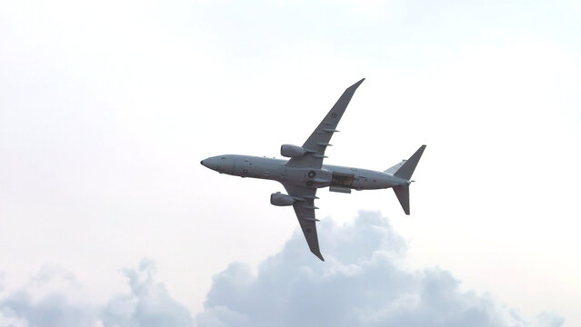 Military Maritime Patrol Aircraft Performing Dynamic Aerial Maneuver at Airshow
