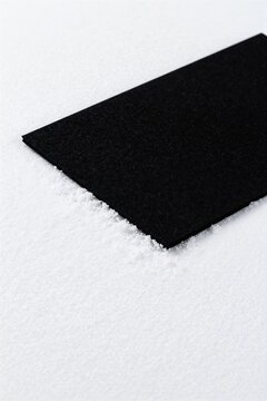 A black felt underlay on fresh snowfield