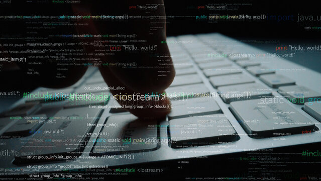 Captured in a close-up, a finger presses a laptop key while lines of code appear, illustrating the dynamic interaction between user and technology in modern programming. Xenic