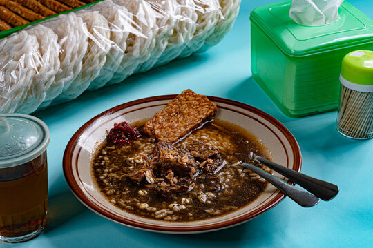Local indonesian warung setup featuring nasi rawon mixed rice and kerupuk crackers