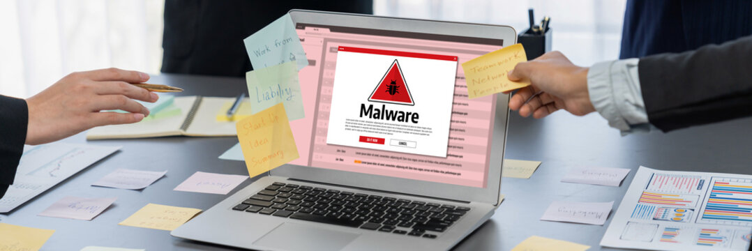 Cyber attacking concept. Malware alert showing on computer screen display scam and threat detection on computer system or online server to be removed brisk.