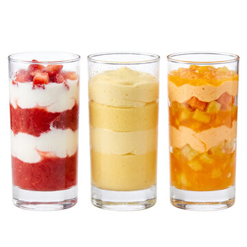 Gourmet fruit mousse desserts in glasses, layered strawberry and mango parfaits, assorted sweet yogurt verrines on white background