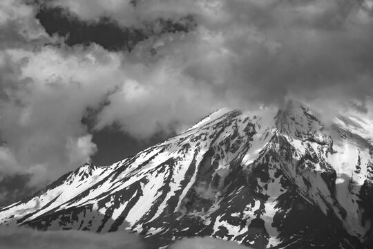 Majestic Mount Ararat peak covered in snow and dramatic clouds in black and white