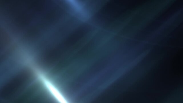 Abstract blue lens flare shines bright light across a dark background.