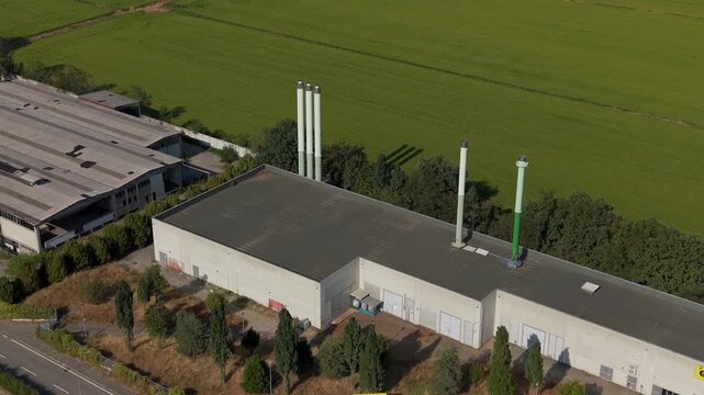 Aerial perspective of a district heating facility in Assago, showing industrial infrastructure supporting centralized heat distribution and local energy services.