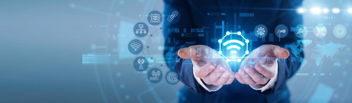 Expert hands hold glowing INTERNET OF THINGS icon. Technician linking smart devices, managing interconnected sensor data network on futuristic virtual screen interface. Concept of wireless ecosystem.