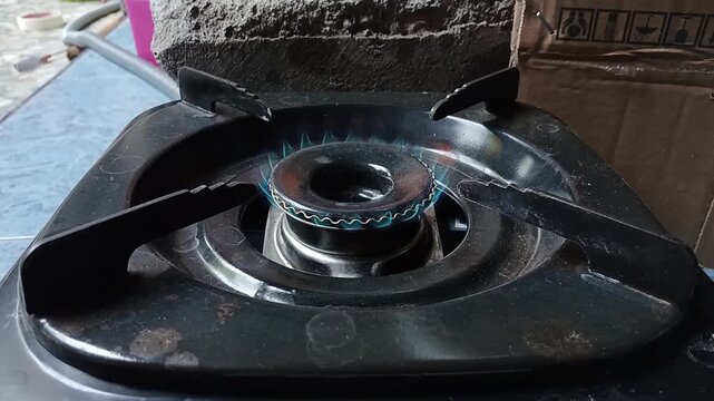 Blue Flame Lighting Up on Portable Gas Stove Burner Close Up