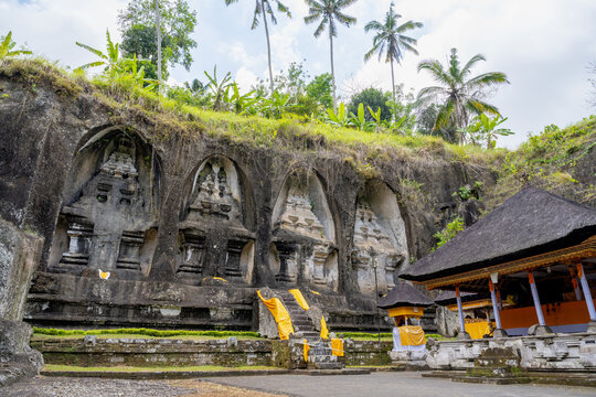 BALI, INDONESIA &ndash; OCTOBER 20, 2024: Ancient 11th century rock-cut candi shrines carved into cliff face at Gunung Kawi Temple.